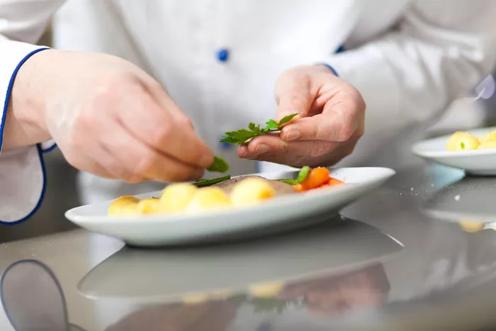 a chef's hands preparing food