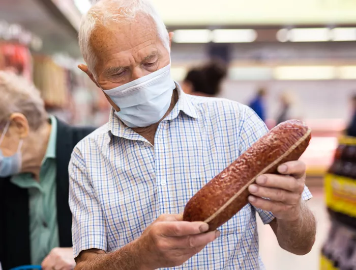 man buying processed meat