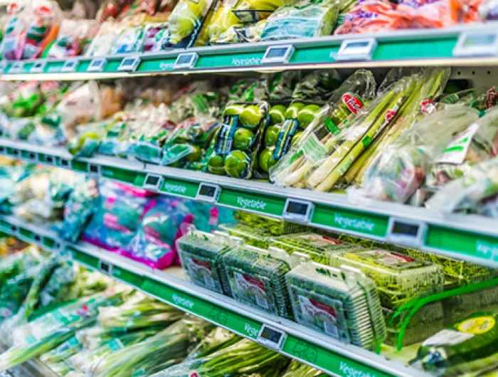 Produce in plastic packaging on on grocery store shelves