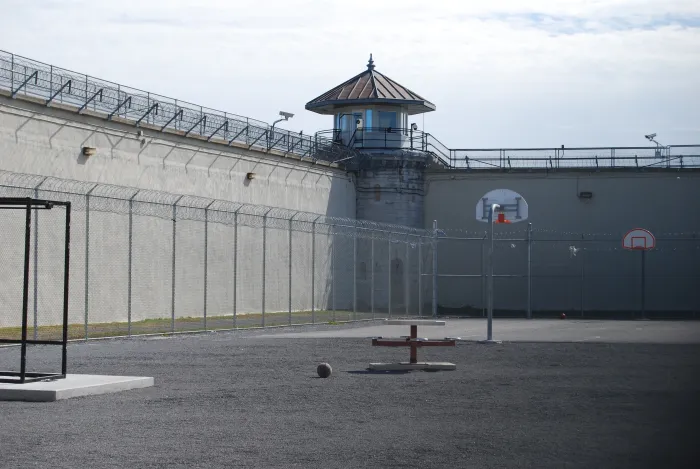 Empty prison courtyard with basketball