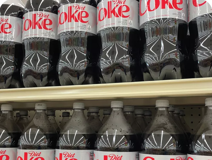 gricery store selves filled with 2 liter bottles of diet coke