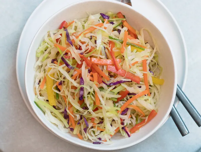 bowl filled with moo shu vegetables and chop sticks
