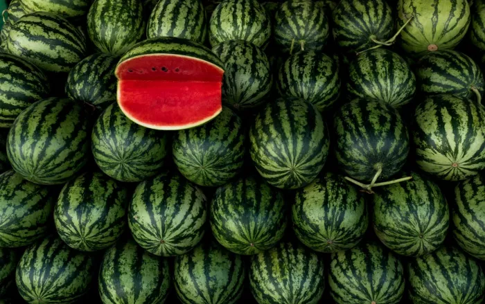Seasonal produce - a stack of watermelons with one split melon on top