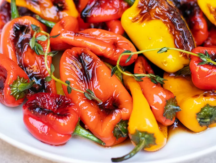 bowl of grilled red, yellow and orange mini bell pepers