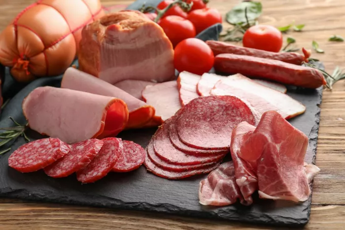 A variety of processed meats on a slate board