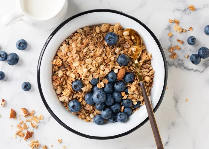 a bowl of granola with blueberries