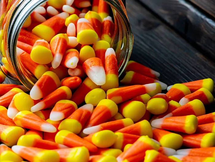 Candy corn spilling from a jar