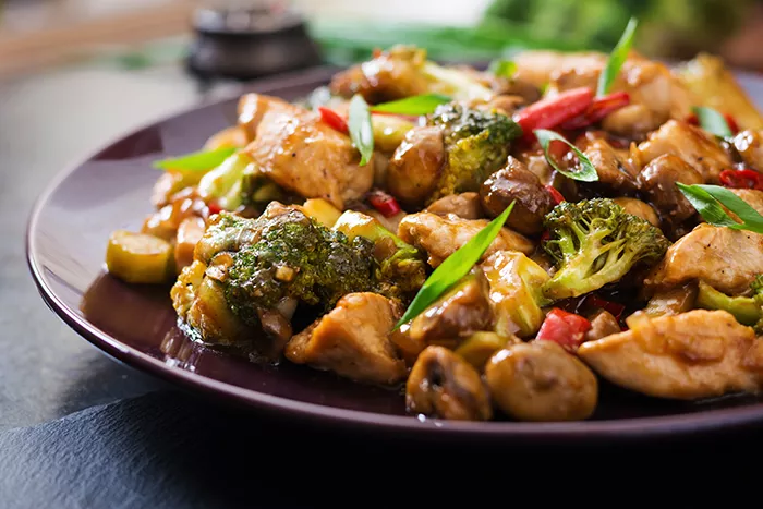 chicken with broccoli dish, topped with peppers