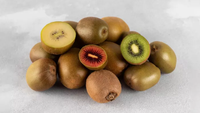 Seasonal priduce - a variety of kiwifruit with halved red, yellow (or golden) and green kiwi