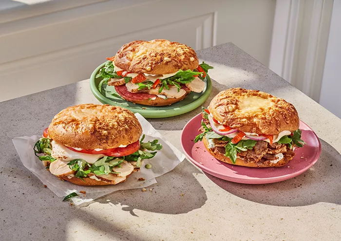3 of Panera's asiago bagel sandwiches on a kitchen counter top
