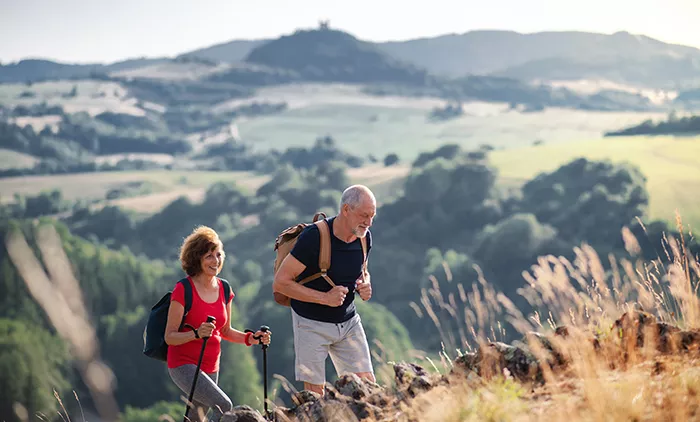two people hiking through rolling hills