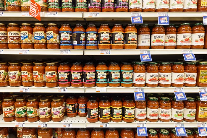 Grocery shelves of marinara sauce