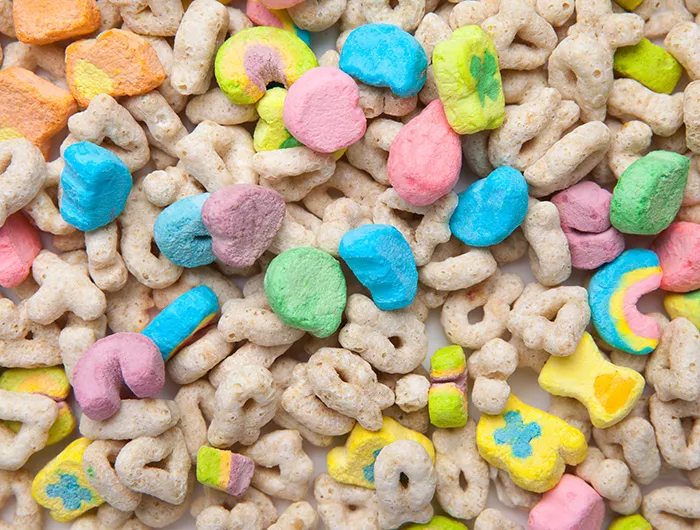 Frosted toasted oat cereal with fun shaped marshmallows on white background