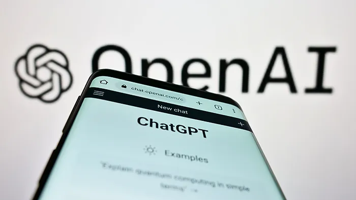 phone screen that says "ChatGPT" with Open AI typed behind the phone