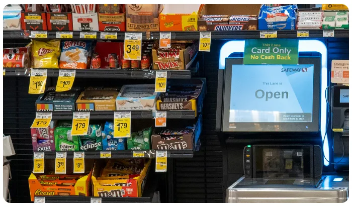 self checkout kiosk surrounded by ultra-processed foods