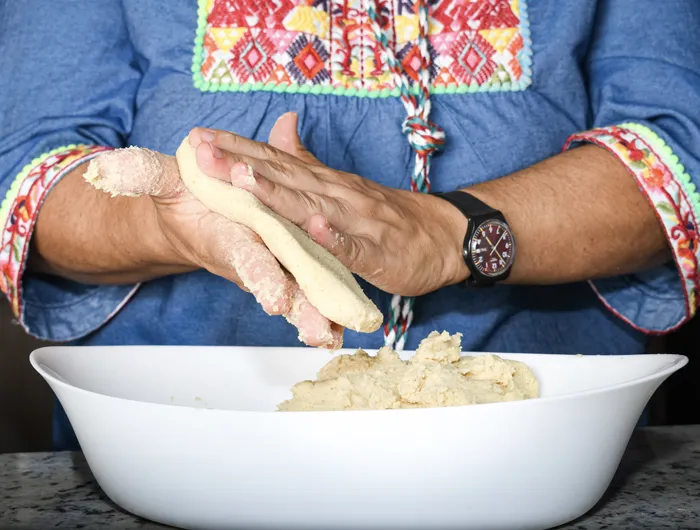 woman's hands making a corn flour tortilla