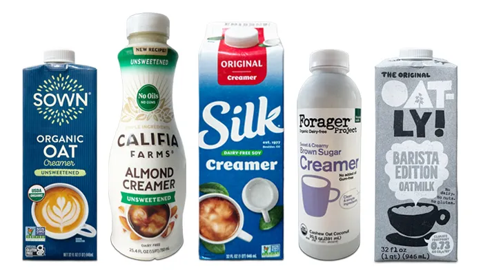 left to right bottles of Sown unsweetened organic oat, Califia unsweetened Almond, Silk unsweetened, Forager Sweet & creamy brown sugar creamer, Oatly barista oat milk.