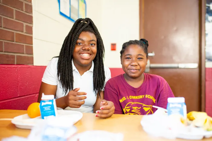 Elementary school students eating school lunches