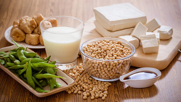 many different soy products laid out on trays, bowls and a cutting board