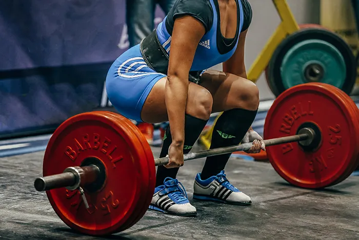 woman doing heavy deadlift in gym