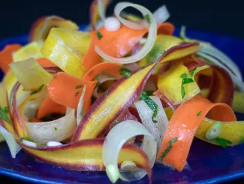 shaved carrots topped with herbs