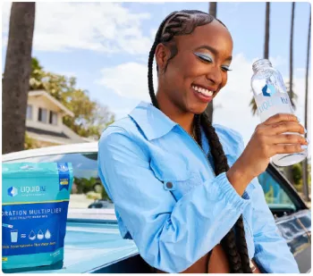 still from Liquid iv ad featuring woman drinking water