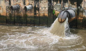 water pipe releasing water into larger body of water