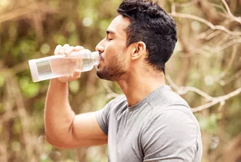 man drinking a bottle of water