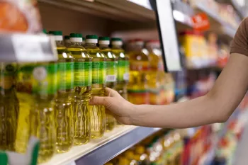 hand grabbing oil off store shelves