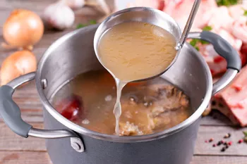 pot and ladle full of broth