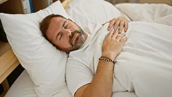 man sleeping in bed