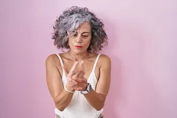 older woman massaging hands