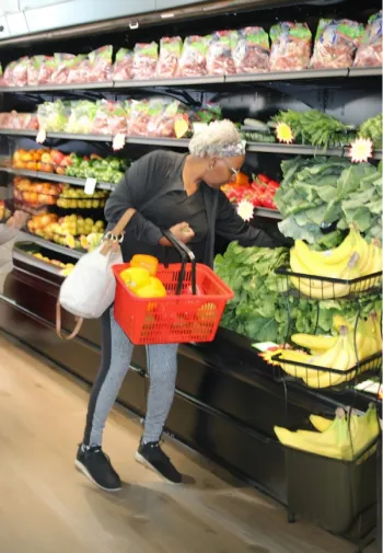 A woman shopping from the produce aisle at the Fresh Start Market.