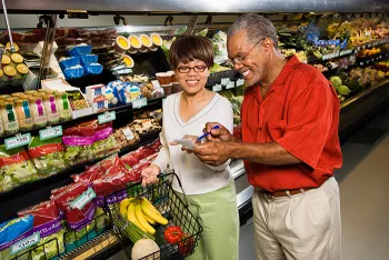 man and woman shopping in grocery store