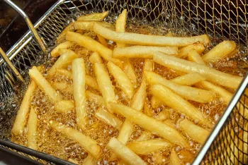 basket of french fries in oil