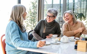 3 older women drinking coffee together