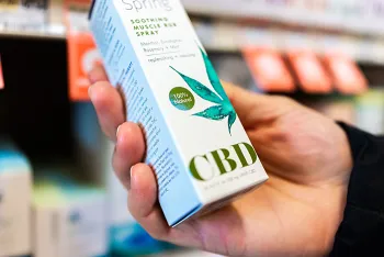 hand holding box of CBD oil