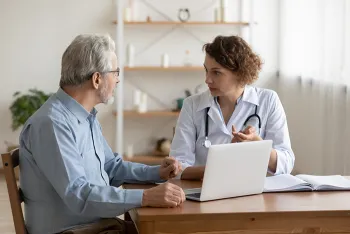 doctor speaking to older man
