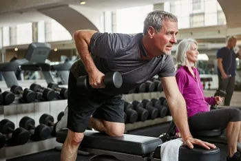 older man weightlifting in the gym