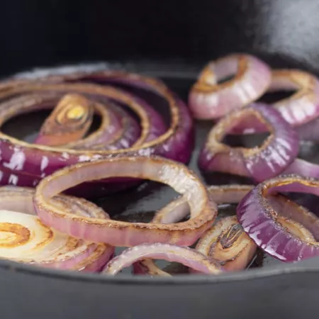 a skillet of sautéed red onion