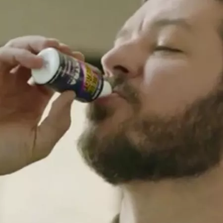 man drinking energy shot