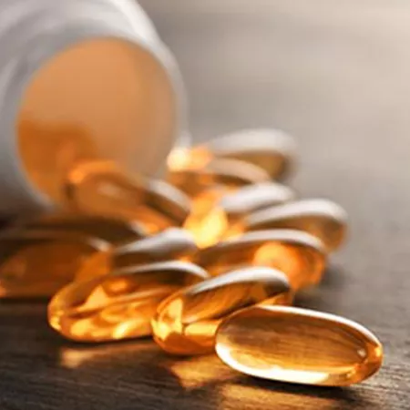 pills laid on a table with bottle in background