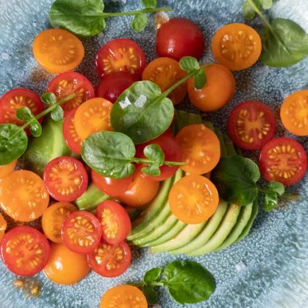 tomatoes and sliced avocado on plate
