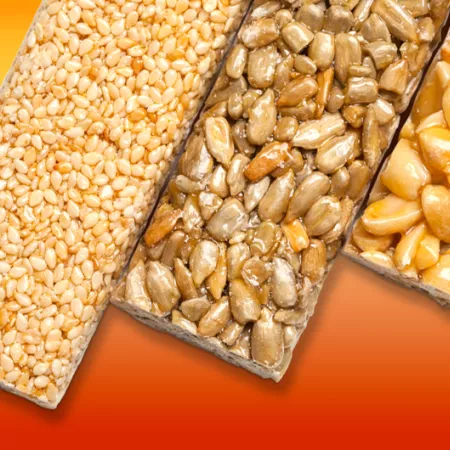 3 granola and nut bars on orange background