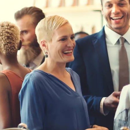 crowd of people talking and smiling