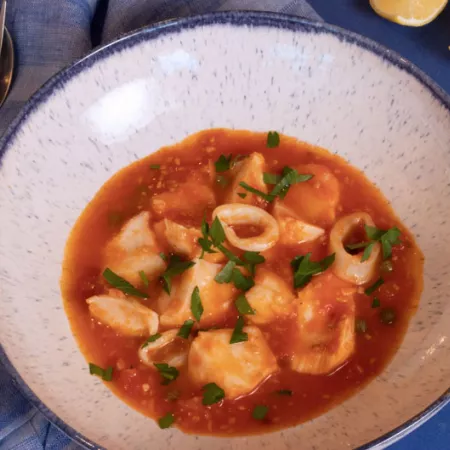 white bowl with seafood stew