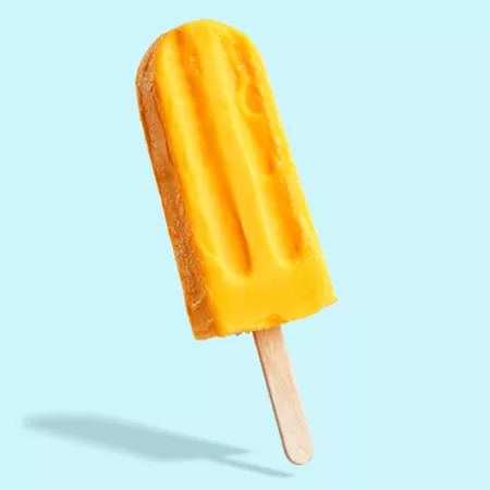 yellow popsicle on light blue background