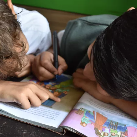 Two young classmates doing schoolwork