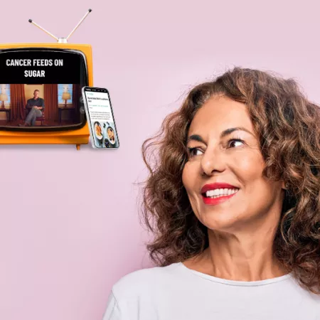 pink background with woman looking towards a tv and phone with diet ads on them