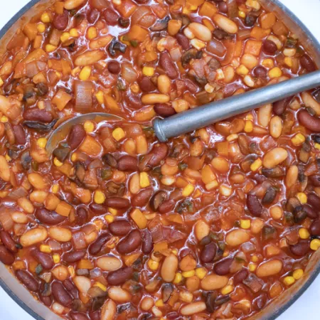 large pot with multi bean chili and a large silver spoon